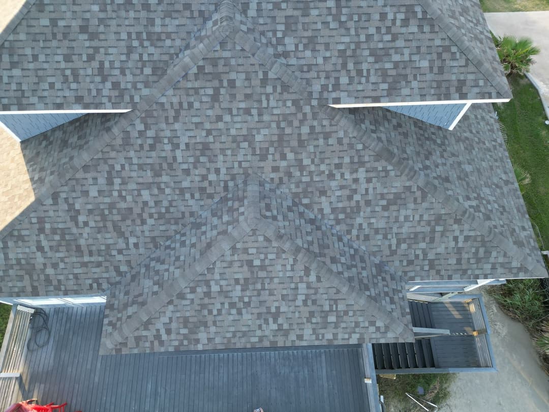 Aerial view of a gray shingle roof on a two-story residential home.